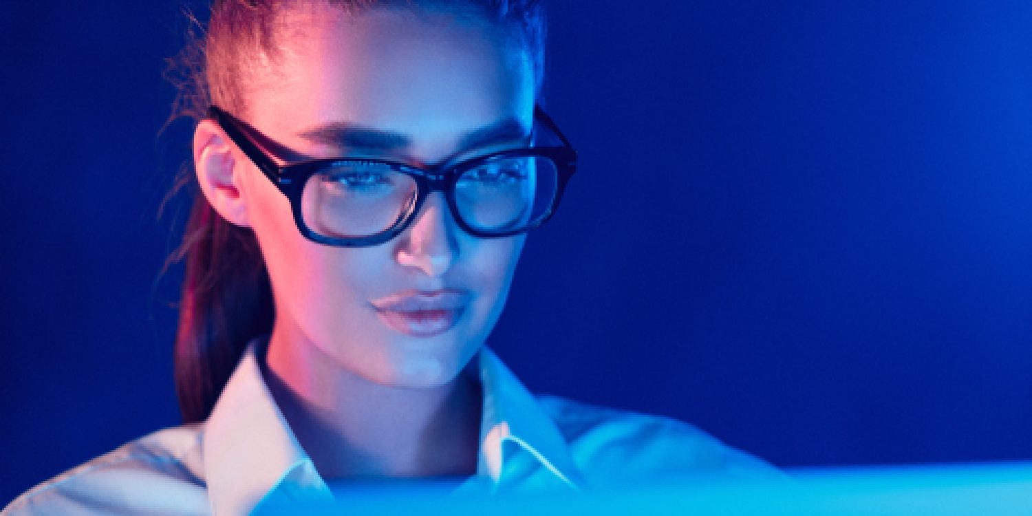 Night,Online,Work.,Woman,In,Glasses,Using,Laptop,In,Colorful